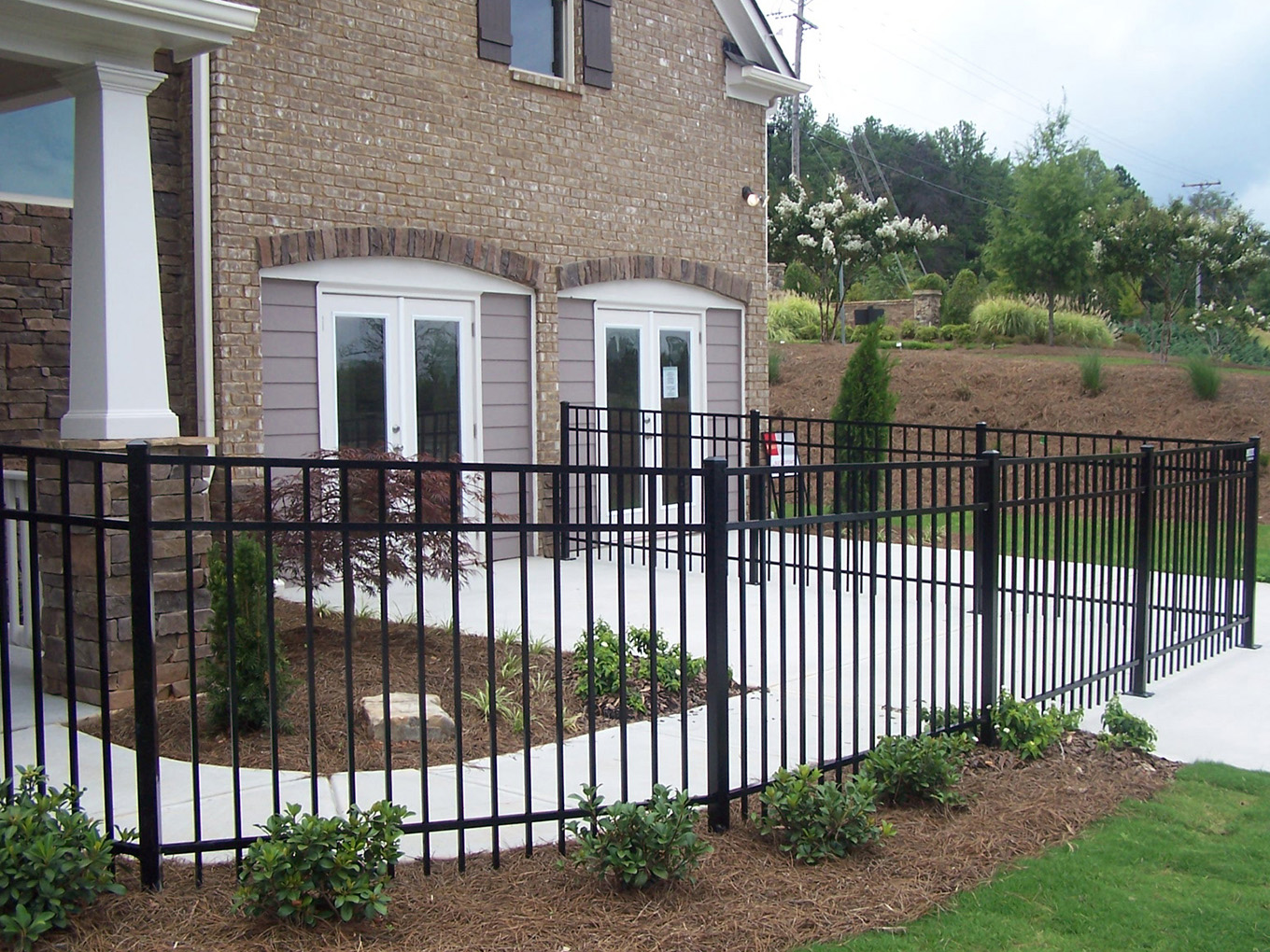 Photo of an aluminum fence surrounding a residential property